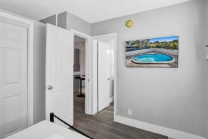 a room with a hallway with a swimming pool on the wall at Rustic Retreats Cozy 1BR For 4 Guests In The Heart Of Fort Lauderdale in Fort Lauderdale