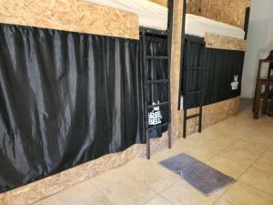 a stage with a black curtain in a room at Green Belly Surf Hostel in El Paredón Buena Vista