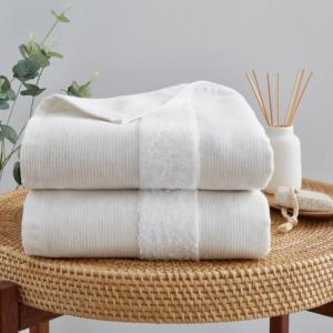 a stack of towels sitting on a wicker table at Bond Street Mayfair Penthouse Sleeps up to 6 in London