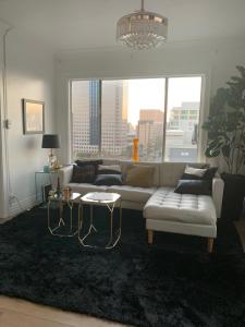 a living room with a couch and a large window at Top Floor for 4- Queen Mary, Ocean, and City View in Long Beach