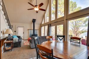 a living room with a dining room table with a ceiling fan at Buckhead Home with On-Site Lake Oconee Access! in Eatonton 
