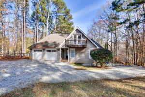 a small house with a porch and a balcony at Buckhead Home with On-Site Lake Oconee Access! in Eatonton 