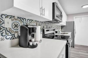 a kitchen with a coffee maker on the counter at Pionciana Getaway 1BR Apartment Near FLL Airport in Fort Lauderdale