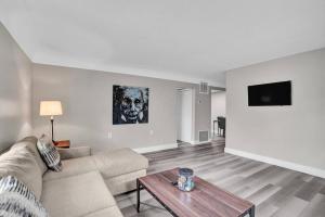 a living room with a couch and a table at Pionciana Getaway 1BR Apartment Near FLL Airport in Fort Lauderdale
