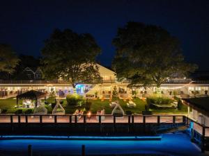 a view of the inn from the water at night at Aqua by American Beech - Adults Only in Aquebogue