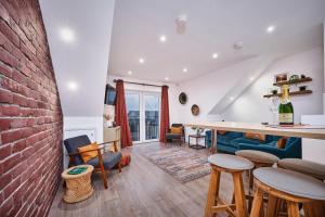 a kitchen and living room with a brick wall at Portstewart Central Loft Apartment in Portstewart