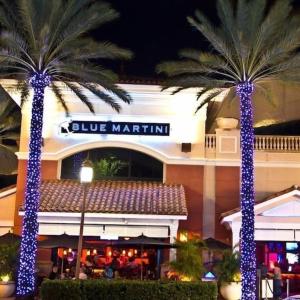 a hotel with palm trees in front of a building at The Oceans Cozy 2BR Apartment in Victoria Park in Fort Lauderdale