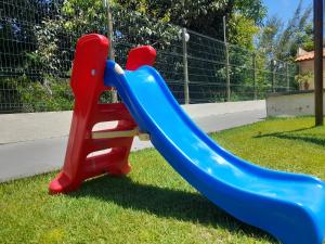 a blue and red slide in a playground at Apartamento flat em condomínio club in Aracaju