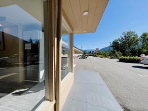 a building with glass windows on the side of a street at Villa Motel in Nelson