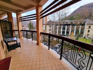 a balcony with a view of a building at Hotel Perla Oltului in Caciulata