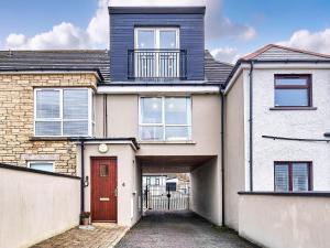 a house with a red door and a driveway at Portstewart Central Loft Apartment in Portstewart