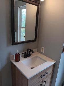 a bathroom with a sink and a mirror at The Residence Room # 2 at The West End *NEW Private Room Close to Downtown in Providence