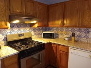 a kitchen with a stove and a microwave at The Residence Room # 2 at The West End *NEW Private Room Close to Downtown in Providence