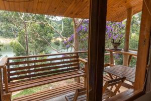 a view from the porch of a cabin with a table and chairs at Casa INTI Refugio Romantico Pague duas noites minimo e a terceira e brinde, menos feriados in Natividade da Serra
