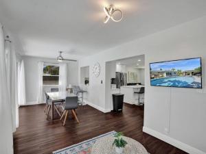 a living room with a table and a dining room at Poolside Paradise Spacious 3BR Haven near Pompano Beach in Pompano Beach