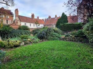 a garden in front of a large house at York Minster Garden in York