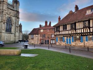 a group of buildings with a church and a street at York Minster View in York