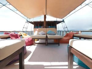 a boat with beds on the deck of a boat at Phinisi Floresta Komodo in Labuan Bajo