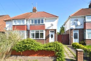 a house with a red fence in front of it at Lily House by YourStays in Crewe