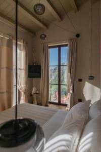 a bedroom with a bed and a large window at Tenuta Zamparina in Montignoso