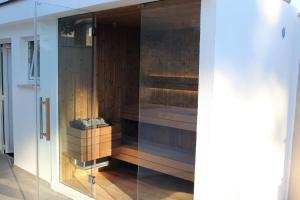 a glass door to a sauna in a house at Villa Salteria 3, pool, private territory, pinery in Rovinj