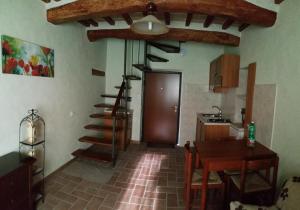 a kitchen with a staircase and a table in a room at Dirindello House Trasimeno in Magione