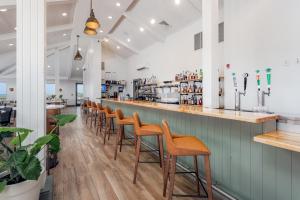 a row of stools at a bar in a restaurant at SpringHill Suites by Marriott Navarre Beach in Navarre