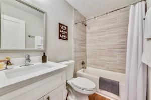a white bathroom with a sink and a toilet and a tub at Near Downtown Dallas - The Dapper Charm in Dallas