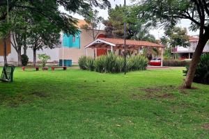 a green park with a bench and a house at Descansa en un espacio acogedor in Guadalajara