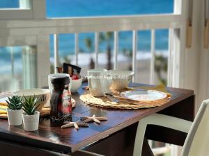 a table with food and a drink on top of it at Ruselo Loft-Studio R607 or Apart 1 bedroom R408 Beachfront in Torrox Costa