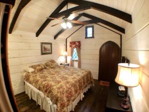 a bedroom with a bed and a ceiling fan at Tiny Home Cottage Near the Smokies #1 Olga in Sevierville