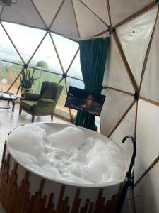 a bath tub in a yurt with a laptop in it at Astral WORLD in Sapanca
