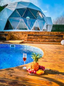 un bicchiere di vino e frutta accanto alla piscina di Astral WORLD a Sapanca