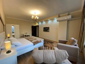a bedroom with a large bed and a living room at Chelay studios Nasr city in Cairo