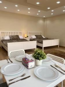 a dining room with two beds and a table with plates at Chelay studios Nasr city in Cairo