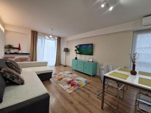 a living room with a couch and a table at Golden Airport Residence in Otopeni