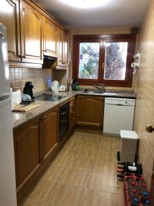 a kitchen with wooden cabinets and a counter top at Chez Maurice avec une belle vue in El Tarter