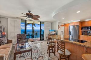 a kitchen and living room with a view of the ocean at Kihei Beach 606 - Direct Ocean Front, Central AC! in Kihei