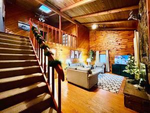 a living room with a staircase and a couch at Cozy cabin close to Virginia Tech and Radford University in Radford