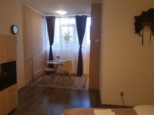 a room with a table and chairs and a window at Stone Bridge Studio in Iaşi