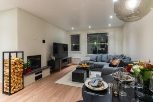 a living room with a couch and a table at Nordic Apartment Katajaranta in Rovaniemi