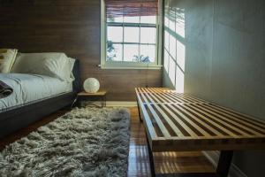 a bedroom with a bed and a window and a rug at The Venice Beachwood in Los Angeles