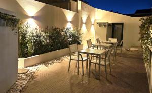 a patio with tables and chairs next to a building at Sweet Spot @ Beach in Estoril