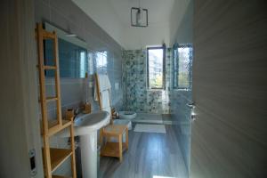 a bathroom with a sink and a toilet and a tub at Nuova Luna in Salerno +41 photos