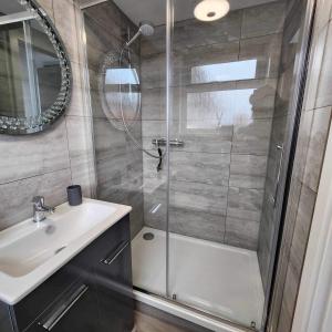 a bathroom with a shower and a sink at Payne’s Pad in Poole