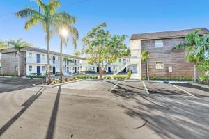 an empty parking lot in front of a building at Rustic Retreats Cozy 1BR For 4 Guests Minutes From Las Olas in Fort Lauderdale