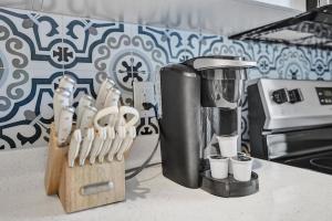 a kitchen counter with a coffee maker and some knives at Rustic Retreats Cozy 1BR For 4 Guests Minutes From Las Olas in Fort Lauderdale