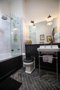 a bathroom with a toilet and a sink and a shower at TOFY (The Old Forge York) in York