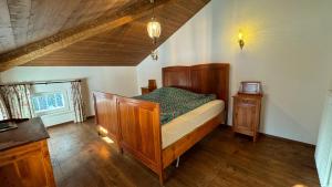una camera con letto in legno e pavimento in legno di Casa Vettori a San Niccolò Comèlico