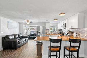 a kitchen and living room with a table and chairs at Ultimate Private Home with Heated Pool in Sarasota